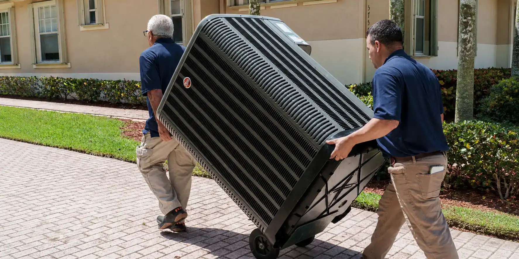AC techs bringing new equipment to a job site.