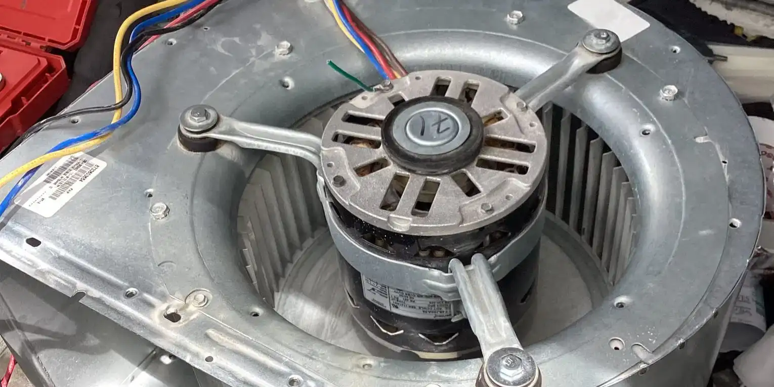 Blower motor and squirrel cage wheel pulled out of an air handler on a Liberty Air and Electric service call, speed taps still wired.