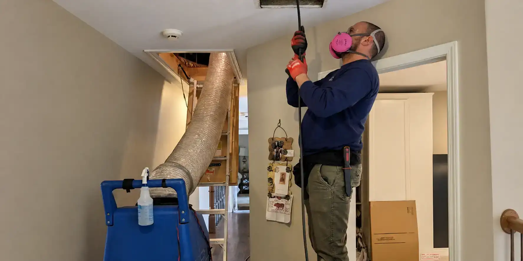 AC tech cleaning ductwork.