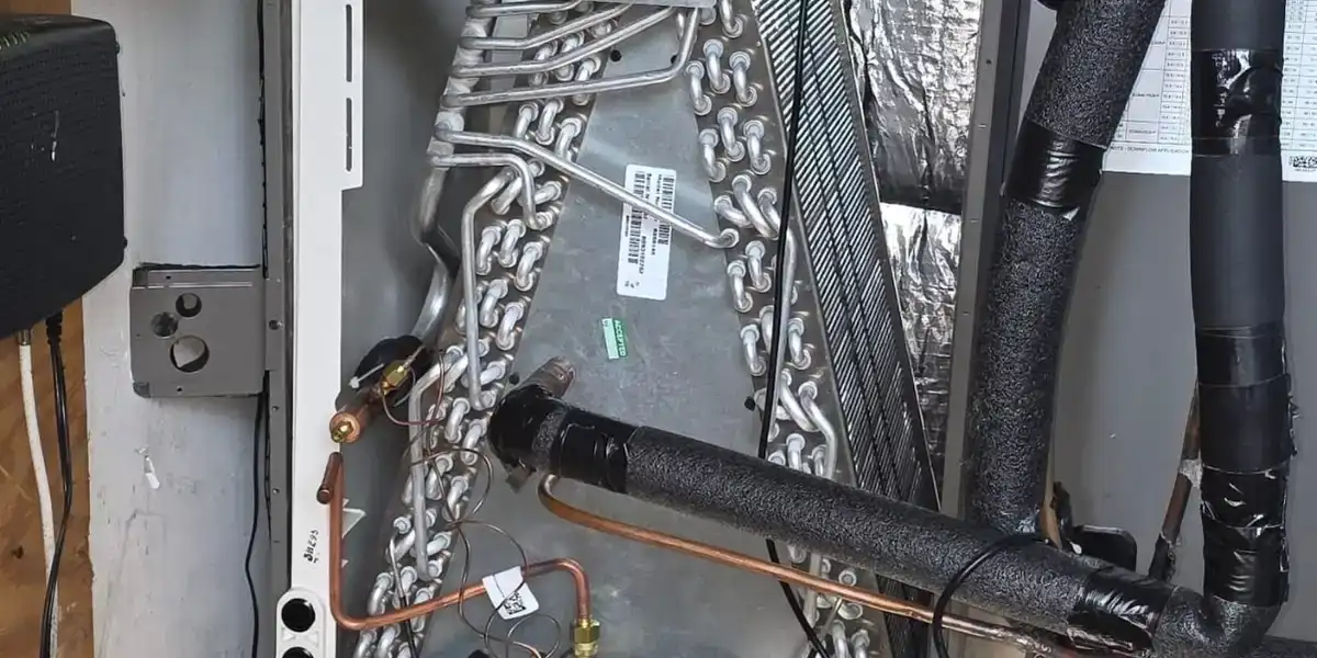 New evaporator coil set in an open air handler cabinet during a Liberty Air and Electric warranty coil replacement in Florida.