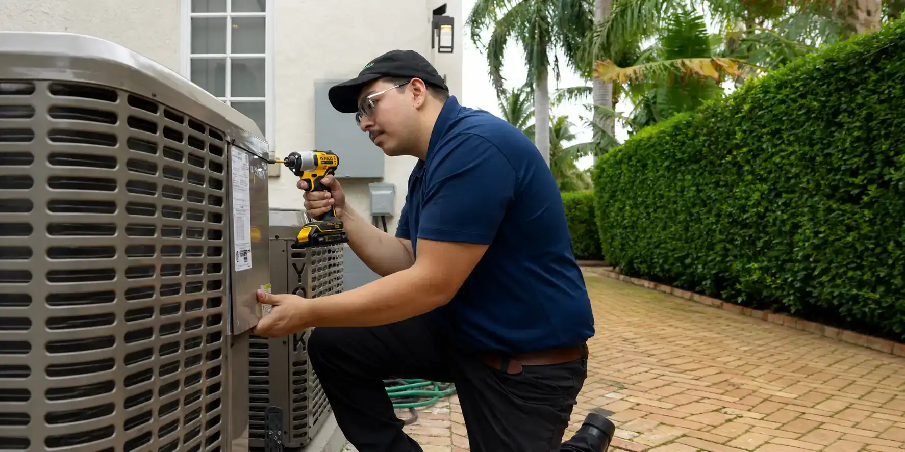 AC tech finishing a maintenance visit.