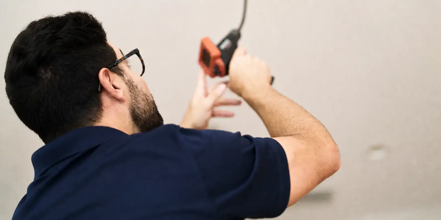 AC tech checking indoor air quality readings.