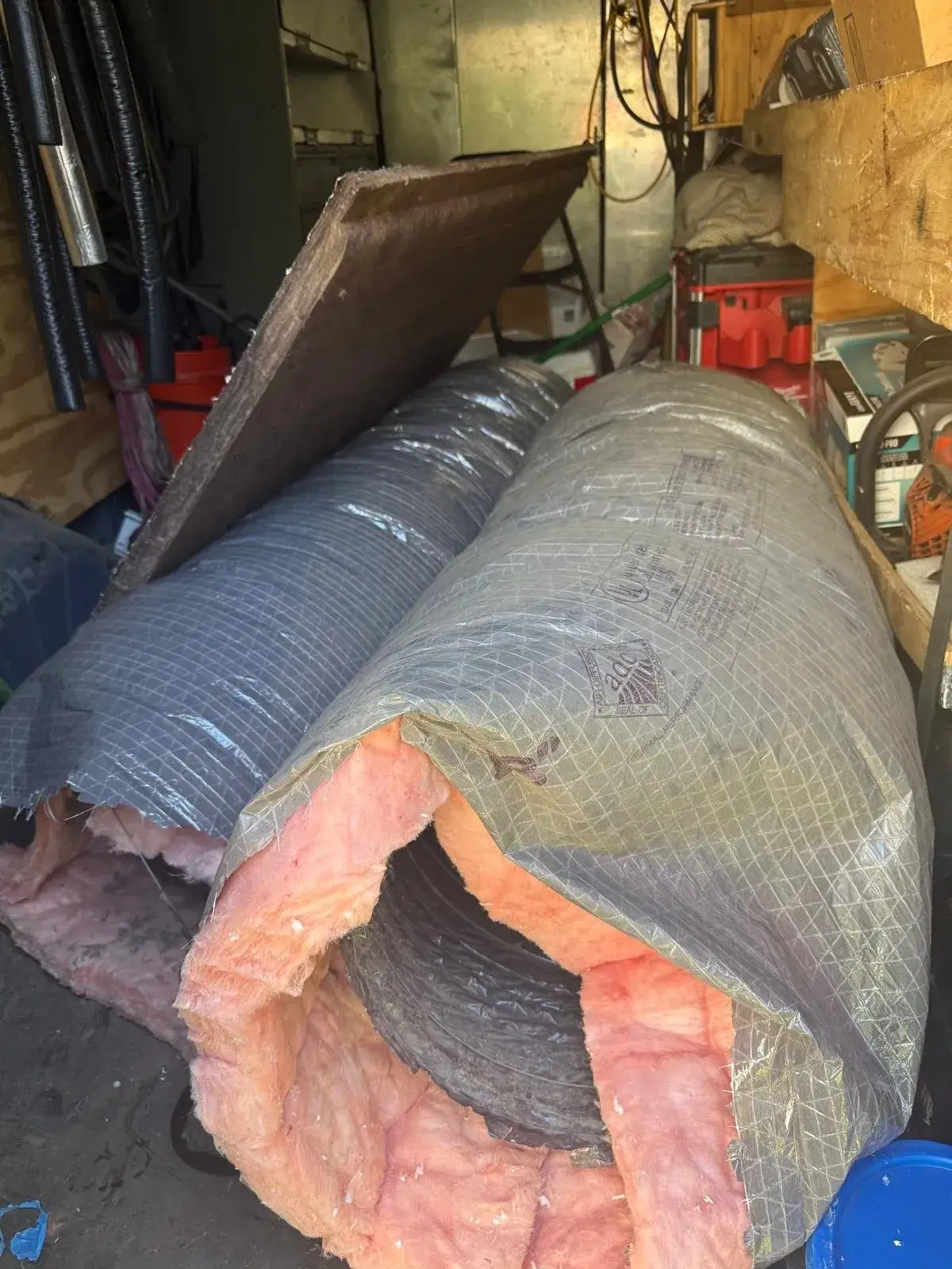 New R-8 insulated flexible duct with an intact vapor jacket and ADC certification seal, staged for a Liberty Air and Electric duct replacement in Florida.