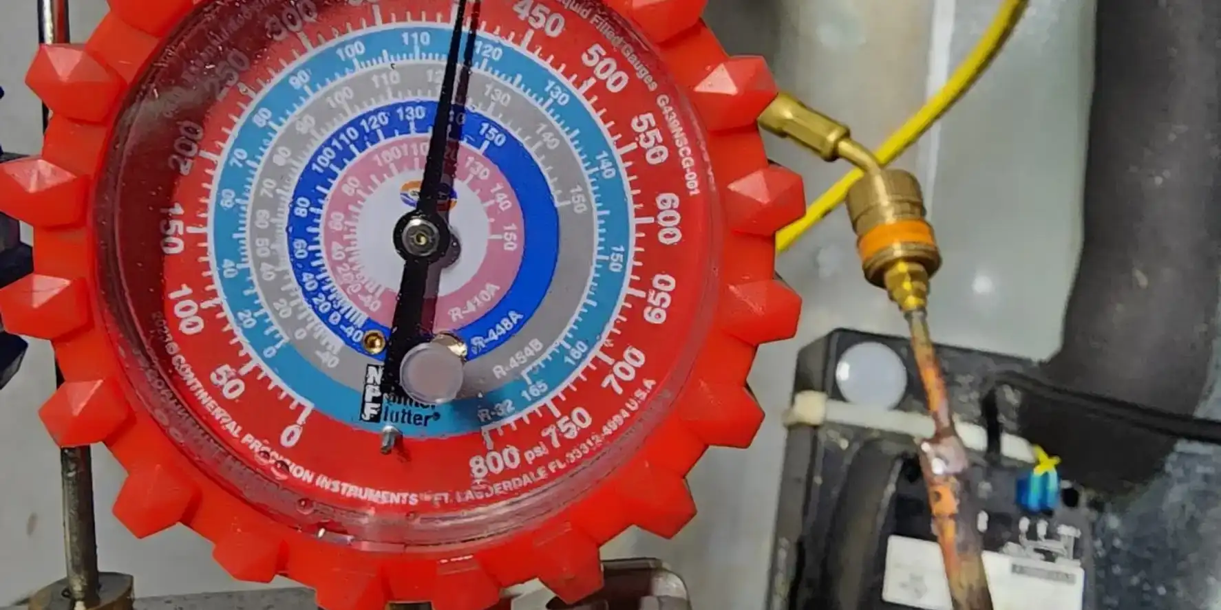 Manifold gauge holding around 400 psi of nitrogen during an AC isolation pressure test.