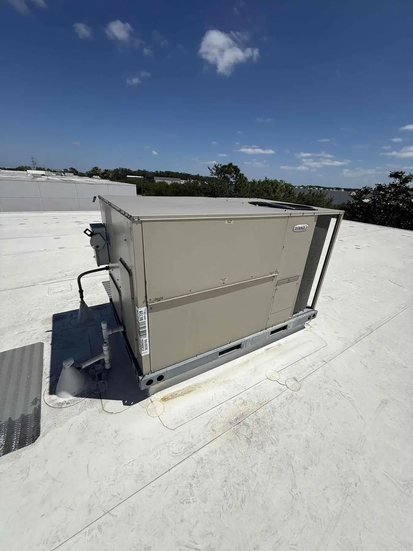 Commercial Lennox package unit installed on a flat rooftop.