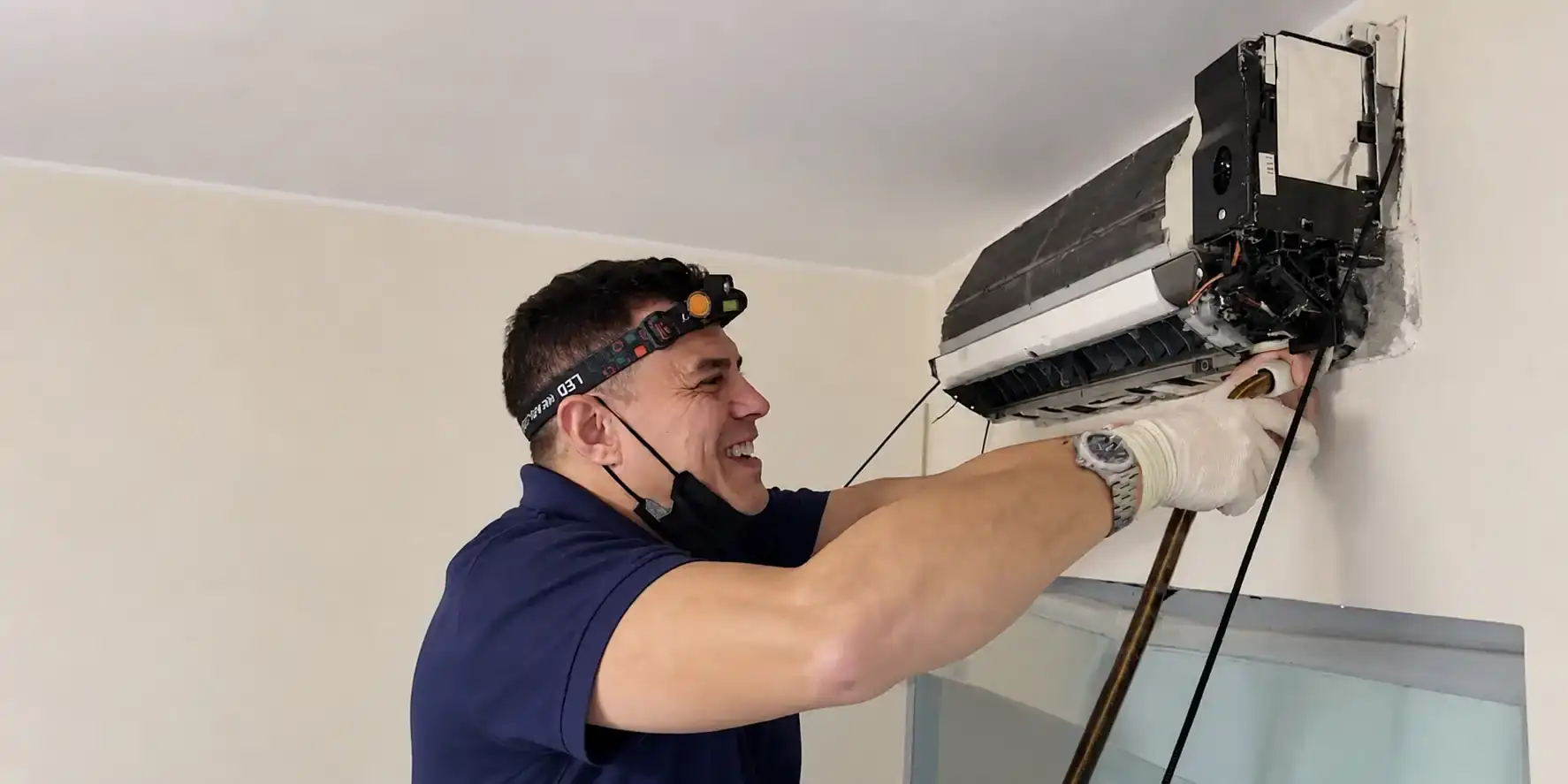 AC tech mounting a mini-split head unit.