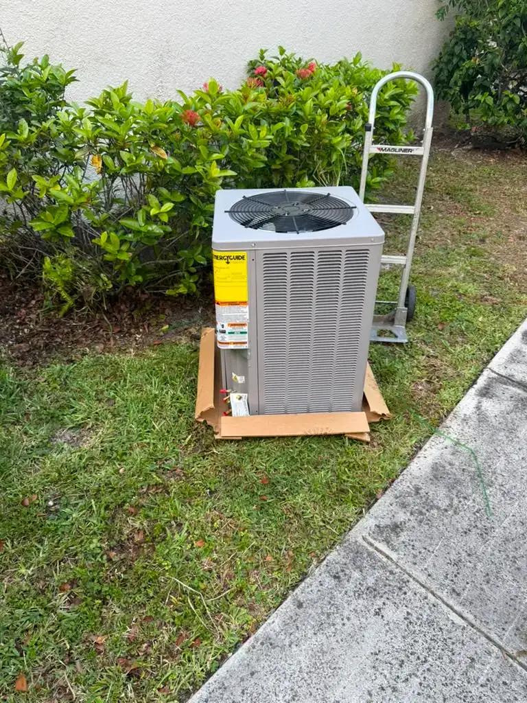 New residential AC condenser staged on the grass beside a Florida home ahead of a Liberty Air and Electric system replacement.