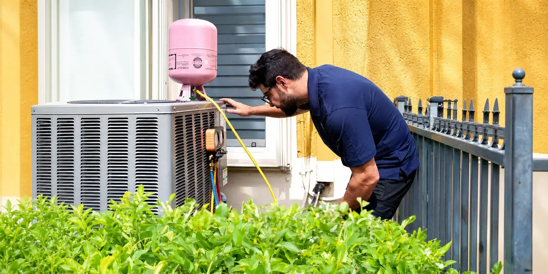 Liberty Air and Electric tech checking refrigerant levels on an outdoor condenser at a Florida home.