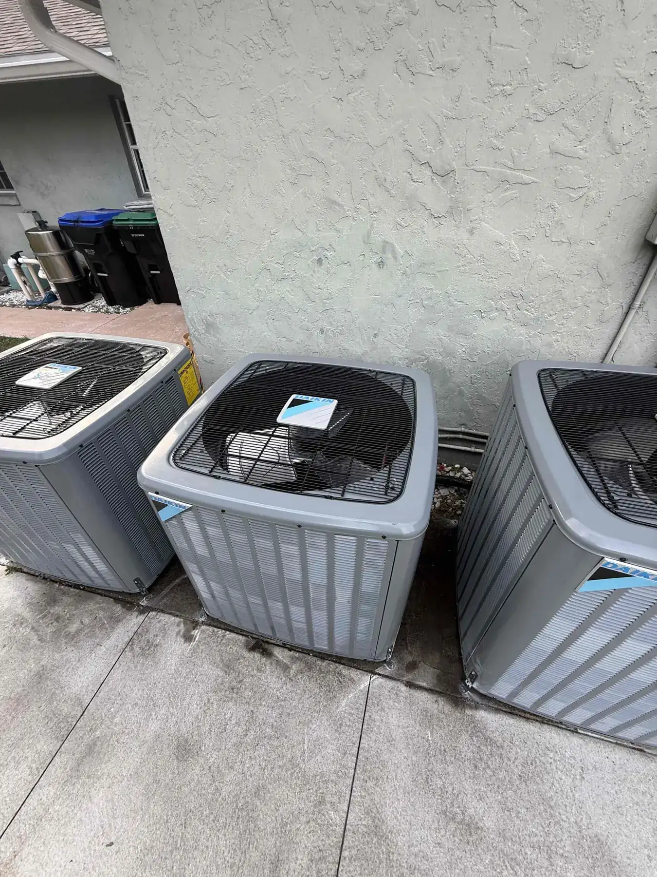 Three new Daikin DH7TC condensers installed side-by-side, replacing aging Trane units.