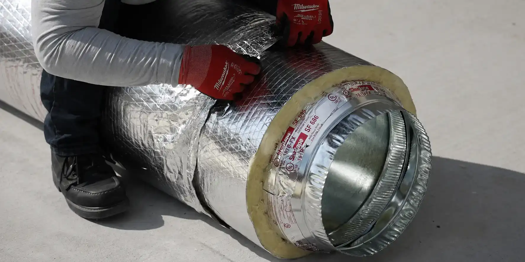 Liberty Air and Electric technician fabricating insulated flex duct.