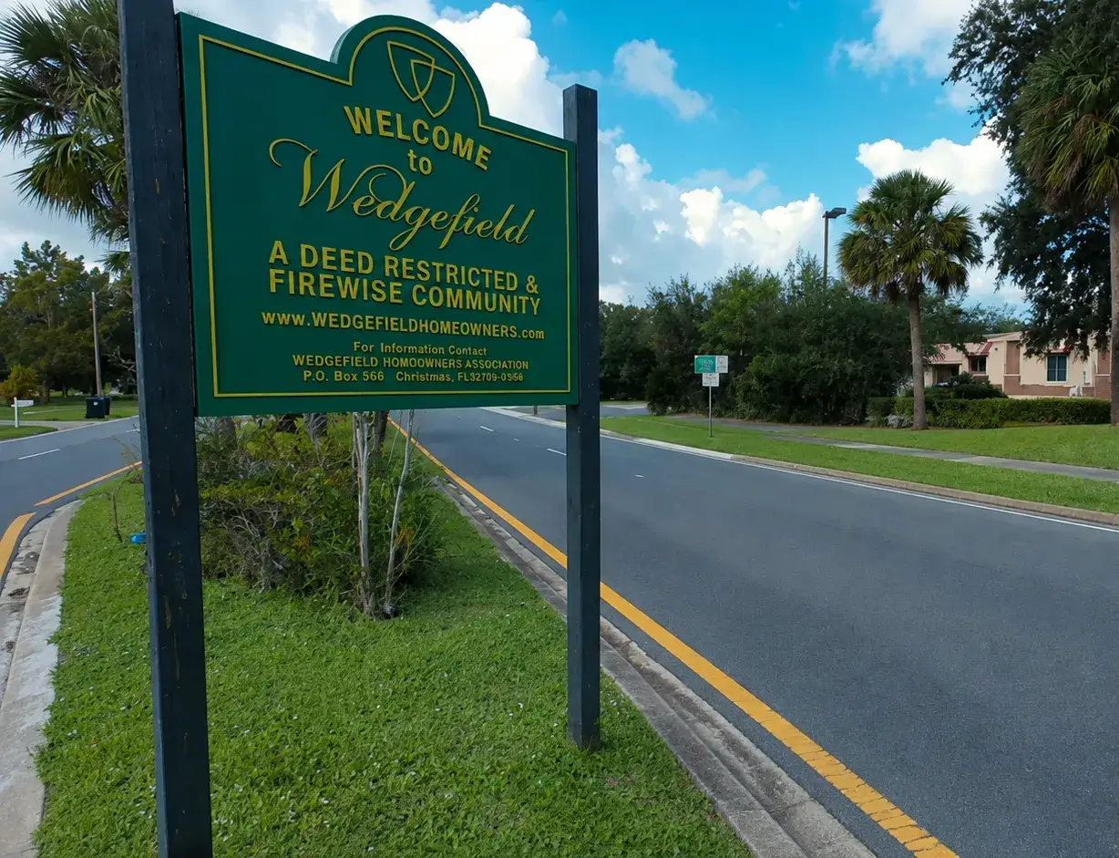 The Welcome to Wedgefield sign at the entrance to the deed-restricted community in the 32833, where Liberty Air and Electric runs AC and electrical calls.